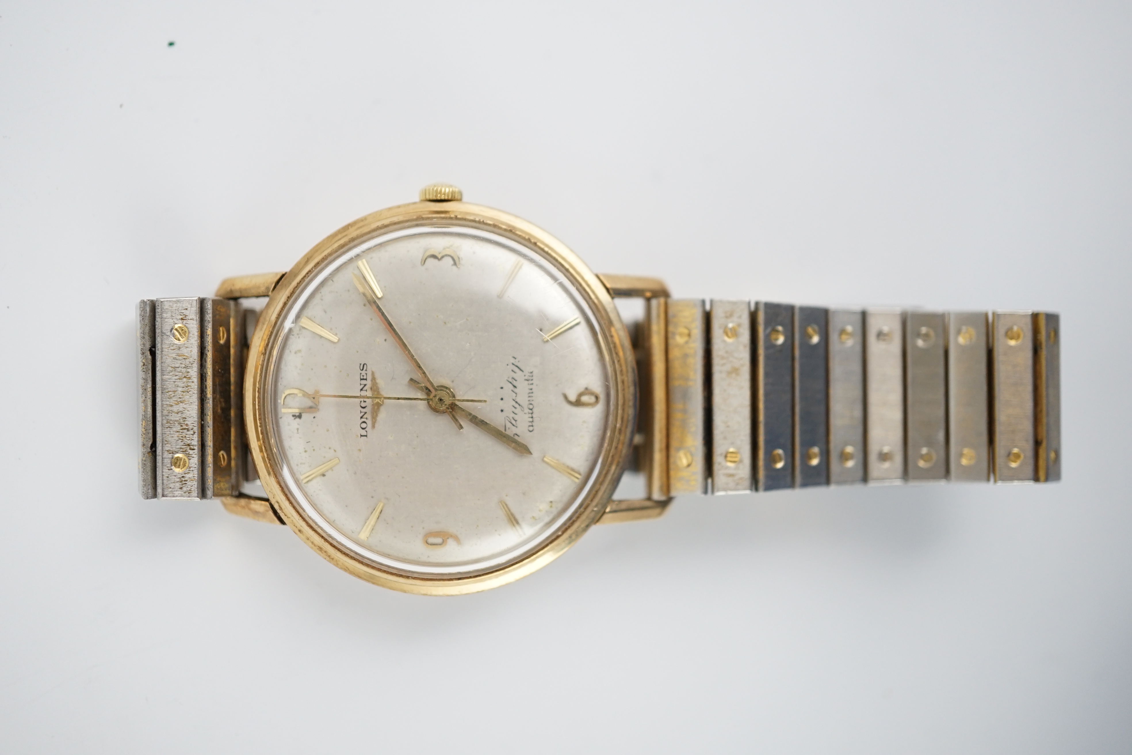 A gentleman’s 9ct gold Longines Flagship Automatic wrist watch, on associated metal bracelet, case diameter 35mm. Condition - poor to fair